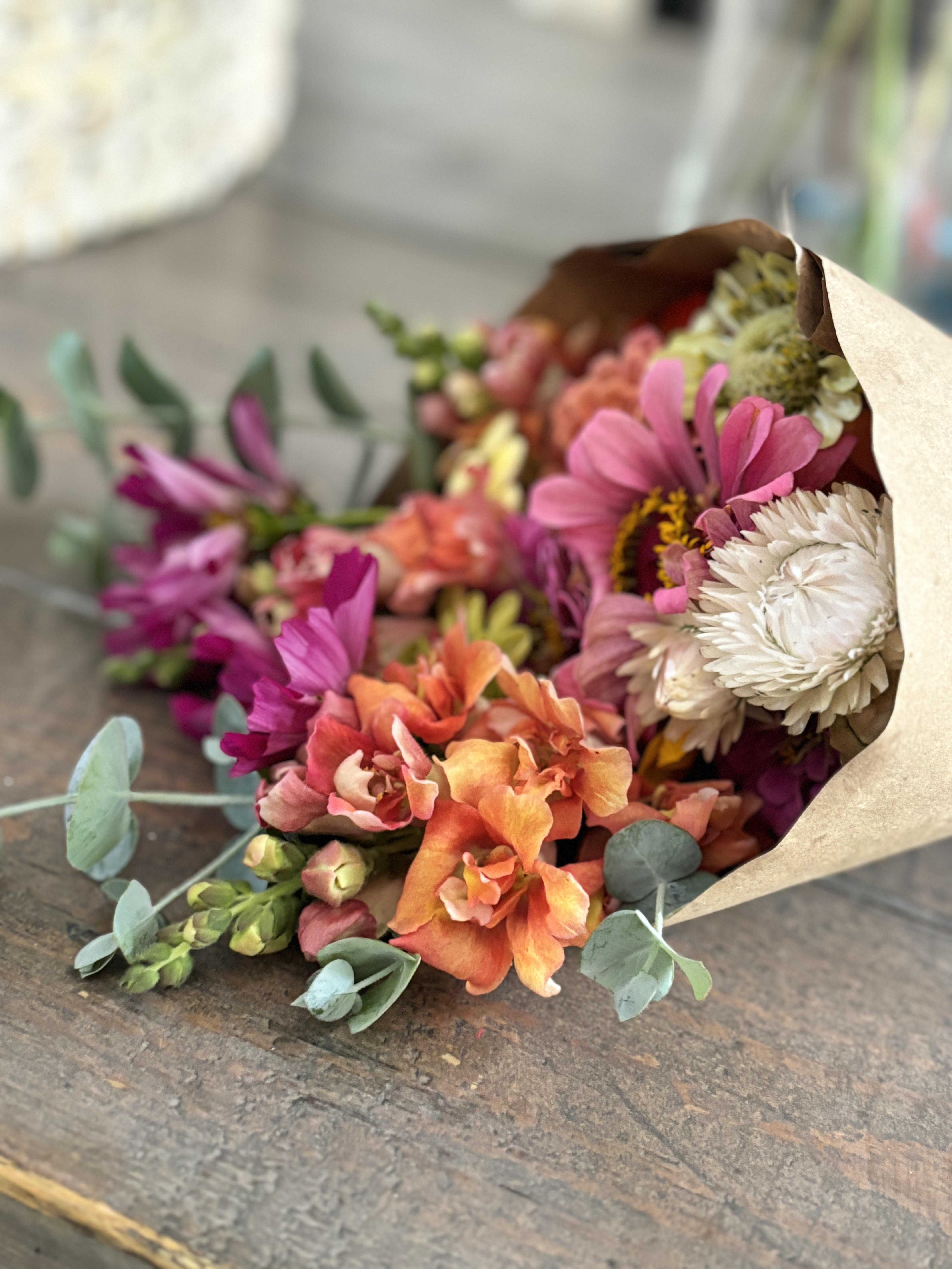 fresh flowers wrapped in brown paper