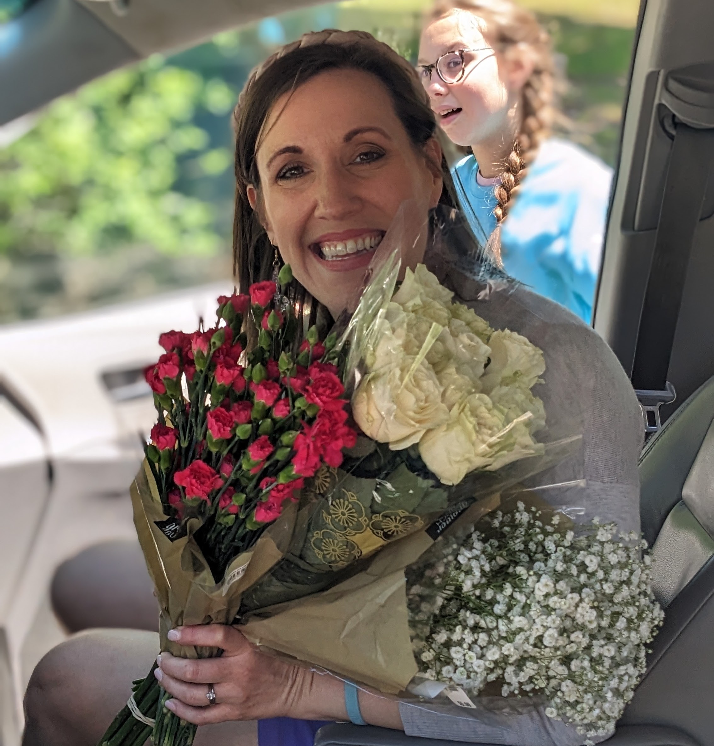 lady holding three bunches of fresh flowers