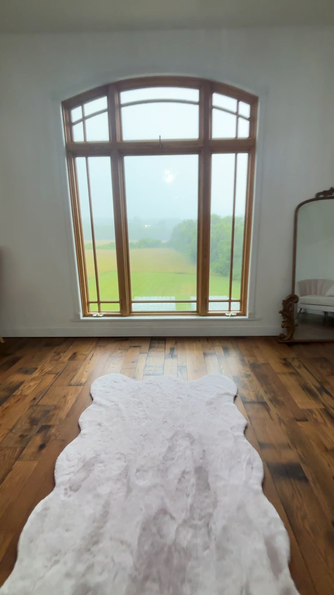 bridal room with large window overlooking rainy wedding site